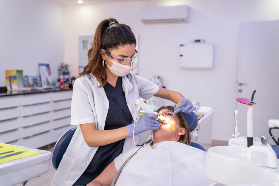 woman inspecting dental patient