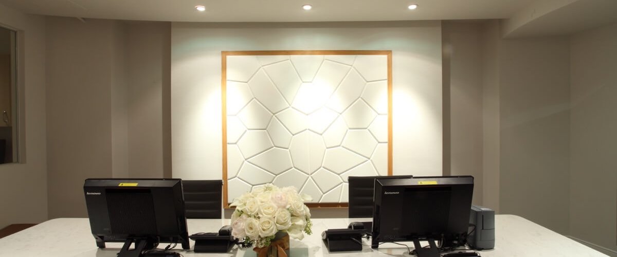 Consultation Desk with view of textured art hanging behind desk