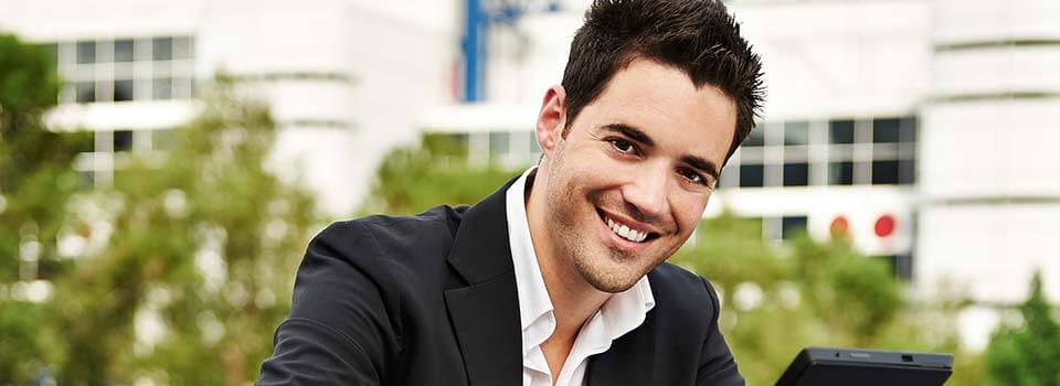 Smiling young man in black suit